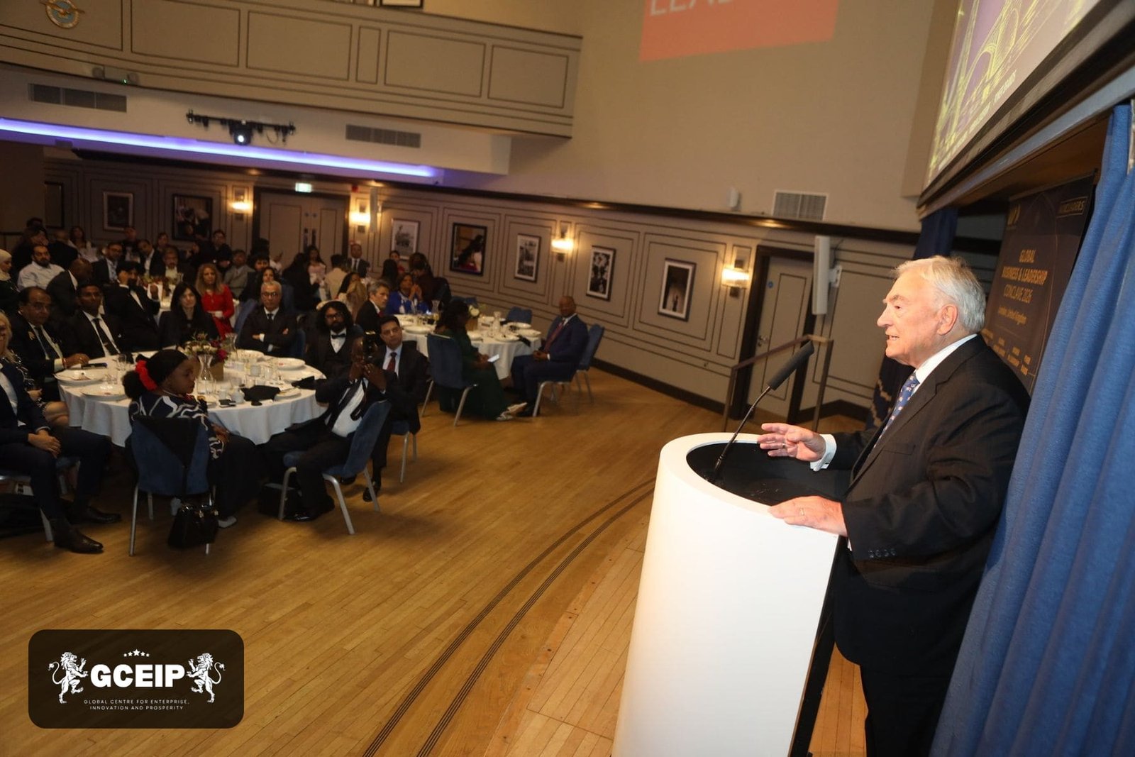 A speaker addresses delegates in Carisbrooke Hall at the Victory Services Club, London